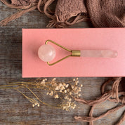Rose quartz facial roller on box