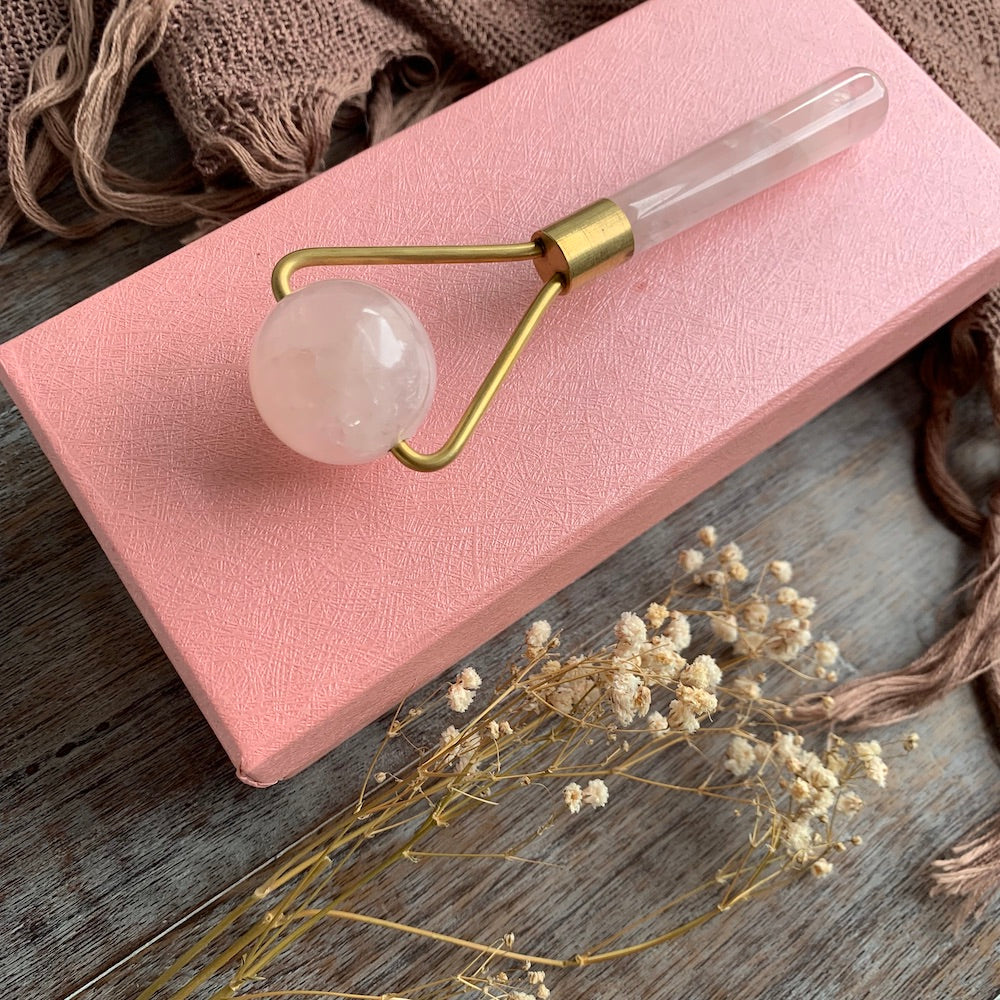 Rose quartz facial roller with flowers