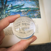 Quartz crystal ball in front of page