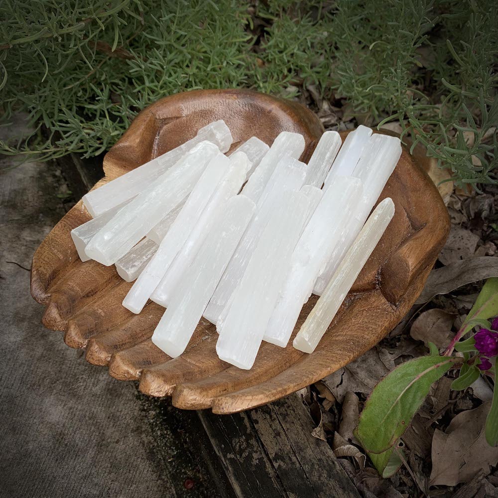 Selenite sticks in wooden bowl