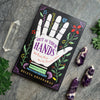 Out of Your Hands book by Beleta Greenaway with chevron amethyst and clear quartz