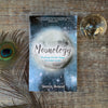 Moonology book by Yasmin Boland with clear quartz orb and peacock feather